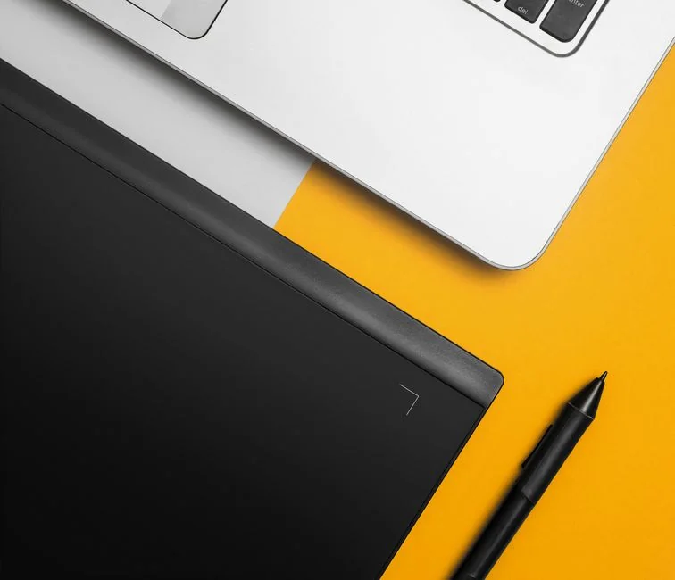 A sleek computer display showing web design projects, highlighting creative visuals in a work environment.